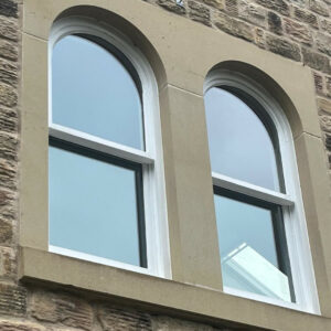 Matching curve-topped sash-windows (from the exterior) (photograph)